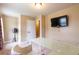 Bright bedroom with a wall-mounted TV, neutral walls, and large white desk at 12275 Styron Dr, Hampton, GA 30228