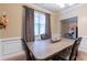 Elegant dining room featuring a classic table setting, decorative curtains, and soft lighting for intimate meals at 12275 Styron Dr, Hampton, GA 30228