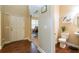 Light-filled entryway featuring hardwood floors, white doors, a view of the office, and a half-bathroom at 12275 Styron Dr, Hampton, GA 30228