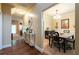 Warm entryway with hardwood floors, decorative console table, and a view of the dining area with neutral tones at 12275 Styron Dr, Hampton, GA 30228