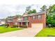 Beautiful two-story brick home with well-manicured lawn, black shutters and a spacious driveway leading to a two-car garage at 12275 Styron Dr, Hampton, GA 30228