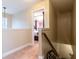 View from hallway overlooking the stairs and an elegant bedroom featuring a four-poster bed at 12275 Styron Dr, Hampton, GA 30228