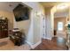 Hallway with hardwood floors, leading to other rooms with neutral paint, doors, and natural light at 12275 Styron Dr, Hampton, GA 30228