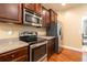 A kitchen featuring wood cabinets, stainless steel appliances, and granite countertops at 12275 Styron Dr, Hampton, GA 30228