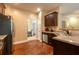 A kitchen area showcasing stainless steel appliances, granite countertops, and wood flooring at 12275 Styron Dr, Hampton, GA 30228