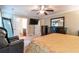 Comfortable main bedroom featuring a ceiling fan, TV, and en-suite bathroom at 12275 Styron Dr, Hampton, GA 30228