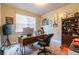 Cozy office space with a large desk, comfortable chair, and natural light streaming through the window at 12275 Styron Dr, Hampton, GA 30228