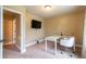 A home office with a modern desk, chair, and mounted television at 12275 Styron Dr, Hampton, GA 30228