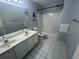 Bathroom with dual sinks, large mirror, tile floors, and shower-tub combo at 2295 Amberbrook Lane Ln, Grayson, GA 30017