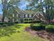 Elegant brick home featuring a well-kept lawn, mature trees, and a welcoming entrance at 2295 Amberbrook Lane Ln, Grayson, GA 30017