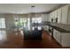 Spacious kitchen with stainless appliances, white cabinetry, dark countertop, and a dark wood center island at 2295 Amberbrook Lane Ln, Grayson, GA 30017