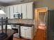 Gourmet kitchen features white cabinetry, granite counters, stainless appliances, and hardwood floors at 2295 Amberbrook Lane Ln, Grayson, GA 30017