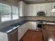 Well-lit kitchen with white cabinets, stainless steel appliances, granite countertops and large sink at 2295 Amberbrook Lane Ln, Grayson, GA 30017