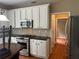 Bright kitchen features stainless steel appliances, white cabinets, and granite countertops at 2295 Amberbrook Lane Ln, Grayson, GA 30017
