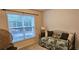 Bedroom with a daybed, large window, and a wicker chair at 3150 Woodwalk Se Dr # 3112, Atlanta, GA 30339