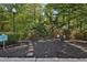 Community dog park with a mulched play area and a clear path to pool access, perfect for pet owners at 3150 Woodwalk Se Dr # 3112, Atlanta, GA 30339