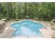 Lovely community pool area surrounded by mature trees and many lounge chairs at 3150 Woodwalk Se Dr # 3112, Atlanta, GA 30339