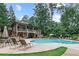 Community pool area with ample seating, mature trees and outdoor umbrellas at 3150 Woodwalk Se Dr # 3112, Atlanta, GA 30339