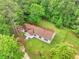 Aerial view of home with lush green surroundings and well-maintained lawn at 4060 Highway 81, Hampton, GA 30228