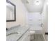 Well-lit bathroom features a granite countertop vanity and shower-tub combo at 4060 Highway 81, Hampton, GA 30228