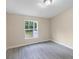 Bright bedroom with a window and light grey, wood-look flooring at 4060 Highway 81, Hampton, GA 30228