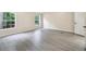 Bright bedroom featuring neutral walls, two windows, and light gray wood-look flooring at 4060 Highway 81, Hampton, GA 30228
