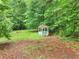 Tranquil backyard featuring a gazebo surrounded by mature trees, offering a peaceful retreat at 4060 Highway 81, Hampton, GA 30228