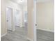 Hallway features light grey, wood-look flooring and white doors at 4060 Highway 81, Hampton, GA 30228