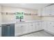This kitchen offers ample counter space, white cabinets, and a stainless steel dishwasher at 4060 Highway 81, Hampton, GA 30228