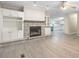 Bright living room with a stone fireplace, built-in shelves, and modern flooring at 4060 Highway 81, Hampton, GA 30228
