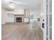 Spacious living room with a stone fireplace, built-in cabinets, and sleek wood-look flooring at 4060 Highway 81, Hampton, GA 30228
