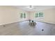 Spacious room features a ceiling fan, updated floors, and large windows at 4060 Highway 81, Hampton, GA 30228