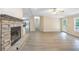 Bright living room with a stone fireplace, built-in shelves, and modern flooring at 4060 Highway 81, Hampton, GA 30228