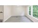 Bright living room with two windows and grey, wood-look flooring at 4060 Highway 81, Hampton, GA 30228