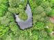 Aerial view of a tree-lined pond, reflecting the sky, and surrounded by lush greenery at 4060 Highway 81, Hampton, GA 30228