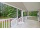 View from the porch showcasing its railings and outdoor space with a surrounding forest at 4060 Highway 81, Hampton, GA 30228