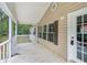 Charming covered porch with white railings, offering a welcoming entrance to the home at 4060 Highway 81, Hampton, GA 30228
