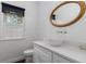 Chic half bathroom boasts modern sink, quartz countertop, bronze-trimmed mirror, and bright natural light at 505 Stedford Lane, Duluth, GA 30097