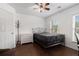 Bright bedroom featuring wood floors, a ceiling fan, and double windows for great natural light at 505 Stedford Lane, Duluth, GA 30097