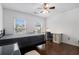 Bright and airy bedroom featuring a ceiling fan, and a comfortable workspace by the windows at 505 Stedford Lane, Duluth, GA 30097