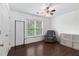 Bedroom featuring hard wood floors, closet, and comfortable gray chair by the window at 505 Stedford Lane, Duluth, GA 30097