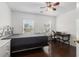 Bright bedroom with a stylish bed frame, wooden floors, and a desk and chair at 505 Stedford Lane, Duluth, GA 30097