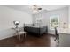 Bedroom with wooden floors and lots of light complete with a metal-framed bed and desk at 505 Stedford Lane, Duluth, GA 30097