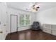 Cozy bedroom with wood floors, featuring a comfy armchair, storage, and soft natural light at 505 Stedford Lane, Duluth, GA 30097