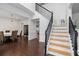Bright foyer with staircase, hardwood floors, and adjacent dining room at 505 Stedford Lane, Duluth, GA 30097