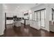 Bright kitchen features white cabinets, black countertops, stainless steel appliances, and a stylish island with bar seating at 505 Stedford Lane, Duluth, GA 30097