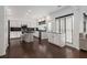 Bright kitchen boasts white cabinets, black countertops and backsplash, and an island with stool seating at 505 Stedford Lane, Duluth, GA 30097