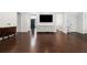 Open-concept living room with dark wood floors, neutral paint, classic furnishings, and abundant natural light at 505 Stedford Lane, Duluth, GA 30097