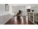Sunlit living space with dark hardwood floors, grand piano, modern cabinets, and a view to the front yard at 505 Stedford Lane, Duluth, GA 30097