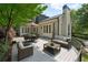 Relaxing backyard deck with patio furniture and dining set overlooking landscaped yard at 5140 Long Island Nw Dr, Sandy Springs, GA 30327